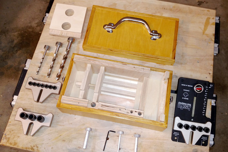 Empty Dowelling Jig Box with All of Its Contents Spread Around It