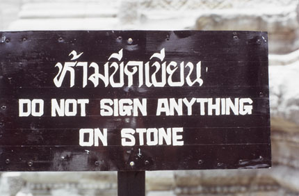 A Sign That Says Do Not Sign Anything On Stone